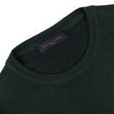 A close-up of a Dark Green Wool Cashmere Crewneck with a visible label on the collar that reads "Daniele Fiesoli Italy." Crafted from a luxurious wool-cashmere blend, this piece is absolutely made in Italy.