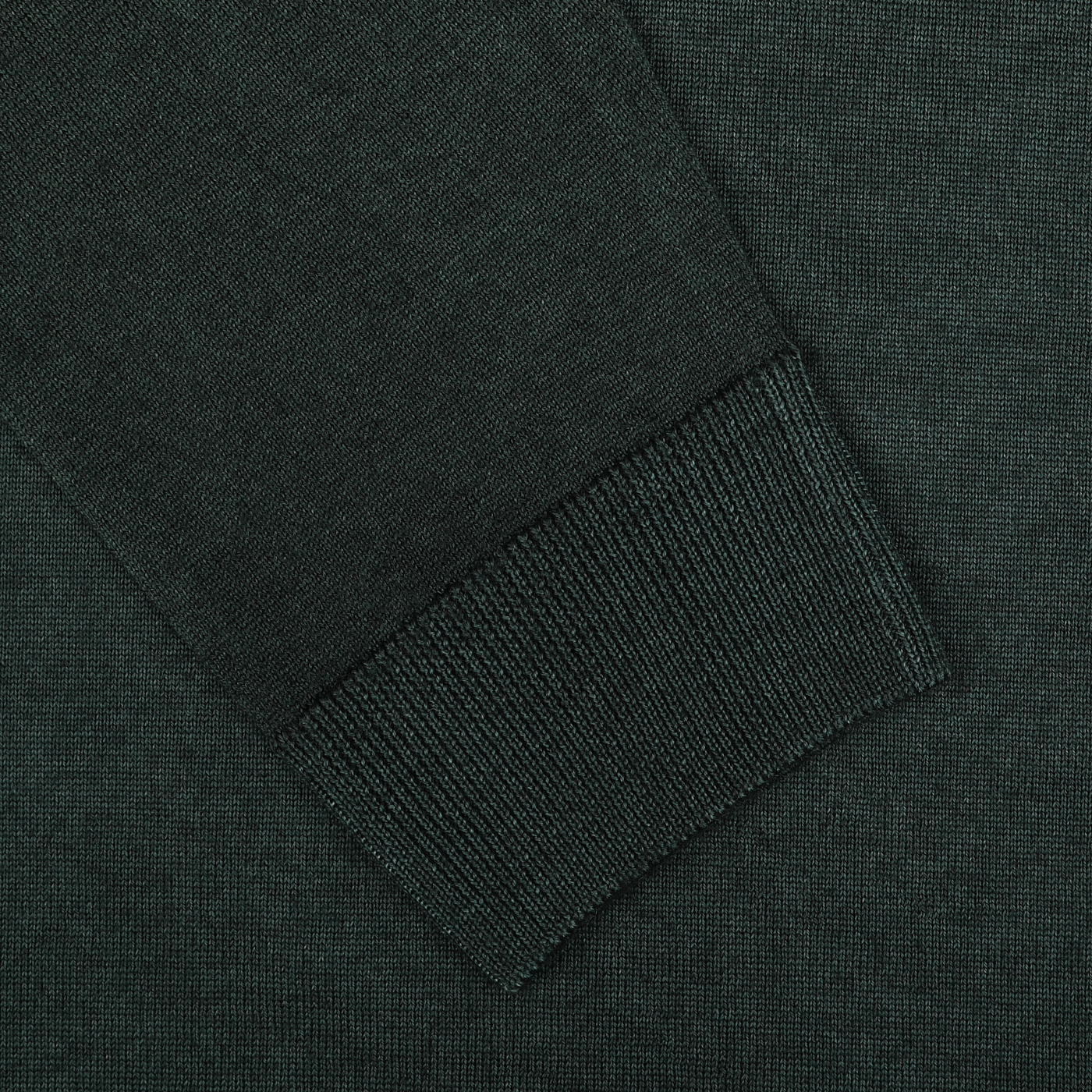 Close-up of a dark green knitted sleeve cuff on a matching fabric background, part of the exquisite Daniele Fiesoli Dark Green Wool Cashmere Crewneck sweater.