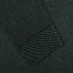 Close-up of a Dark Green Merino Wool Crewneck by Daniele Fiesoli, showing the cuff detail of a sleeve. Made in Italy, the fabric's texture appears even and tightly woven, crafted from extra fine merino wool.