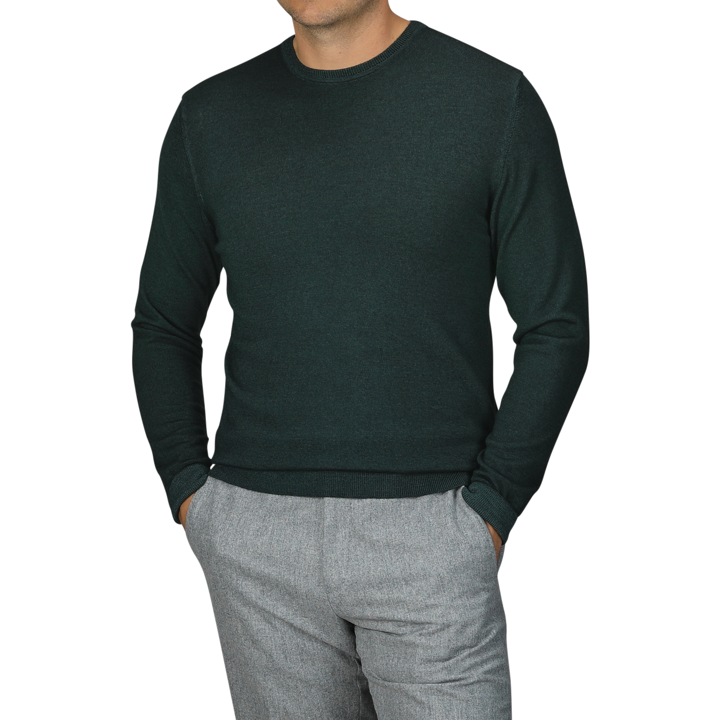 A person wearing the Dark Green Wool Cashmere Crewneck by Daniele Fiesoli, crafted in Italy from a luxurious wool-cashmere blend, paired with gray trousers and hands in pockets.