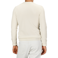 Individual wearing a Daniele Fiesoli Ecru Wool Cashmere Crewneck sweater made in Italy and white pants, captured from behind.