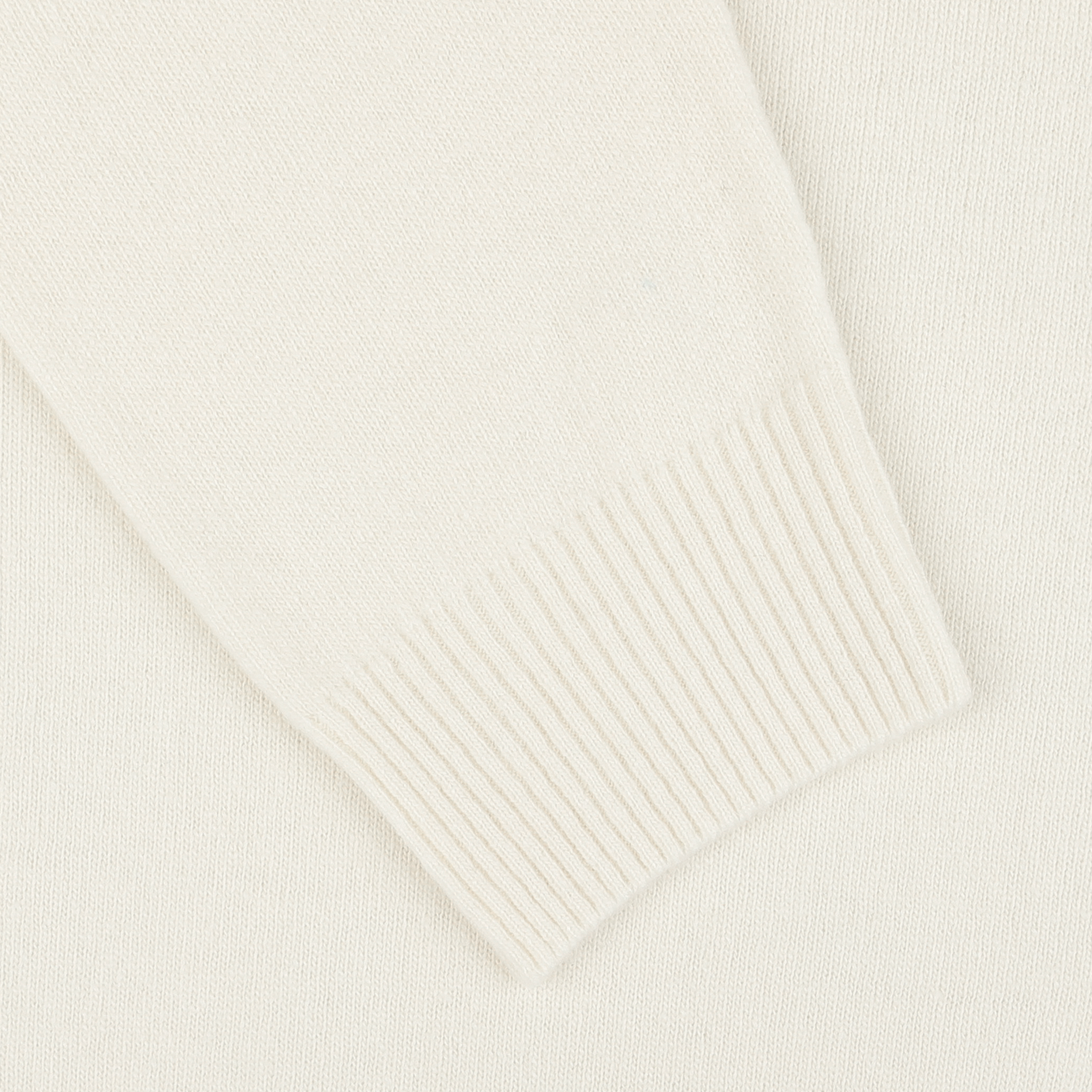 A close-up image of the ribbed cuff of an Ecru Wool Cashmere Crewneck sleeve from Daniele Fiesoli, embodying the luxurious quality typical of garments made in Italy.