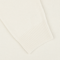 A close-up image of the ribbed cuff of an Ecru Wool Cashmere Crewneck sleeve from Daniele Fiesoli, embodying the luxurious quality typical of garments made in Italy.