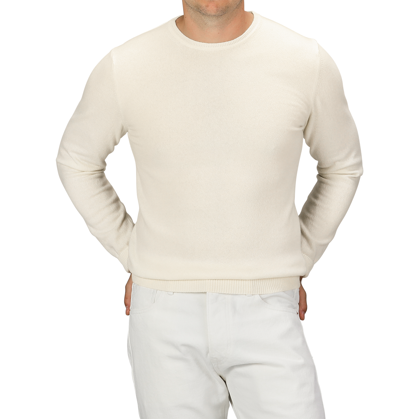 A person wearing a Daniele Fiesoli Ecru Wool Cashmere Crewneck and white pants, standing with hands in pockets, showing their torso and upper legs.