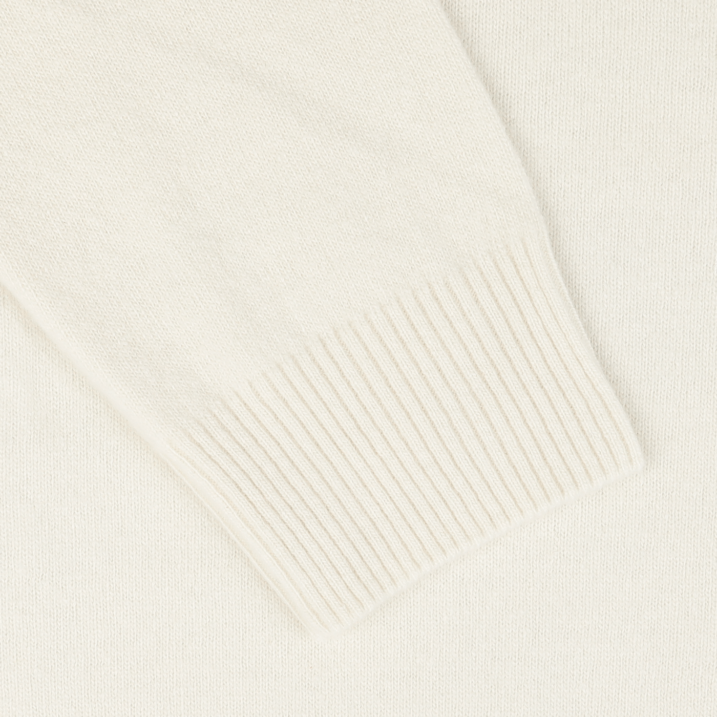 Close-up view of the sleeve with ribbed cuff on the Ecru Wool Cashmere Quarter Zip Sweater by Daniele Fiesoli.