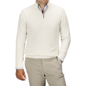 A man wearing a Daniele Fiesoli Ecru Wool Cashmere Quarter Zip Sweater over a light blue dress shirt, paired with beige trousers.