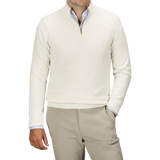 A man wearing a Daniele Fiesoli Ecru Wool Cashmere Quarter Zip Sweater over a light blue dress shirt, paired with beige trousers.