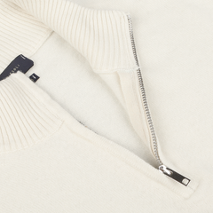 Close-up of a partially unzipped Ecru Wool Cashmere Quarter Zip Sweater, showcasing the metal zipper and a glimpse of the Daniele Fiesoli brand label inside.