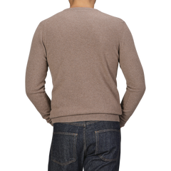 A person wearing a Daniele Fiesoli Light Brown Wool Cashmere Crewneck and dark blue jeans is shown from the back against a plain background.