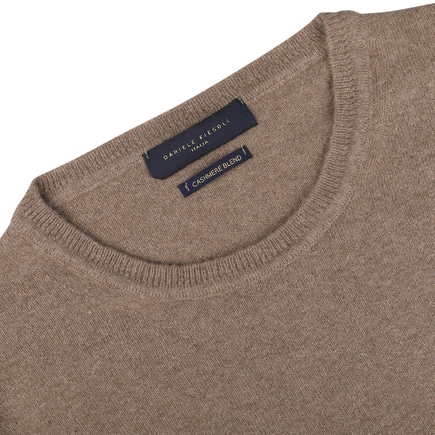 A close-up of the neckline of a light brown wool-cashmere crewneck sweater with a dark blue label that reads "Daniele Fiesoli Fine Knit.