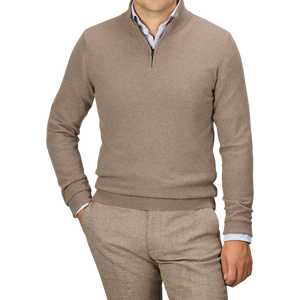 A person wearing a Daniele Fiesoli Light Brown Wool Cashmere Quarter Zip Sweater over a light blue shirt and beige pants, with their left hand in their pocket. Their face is not visible.