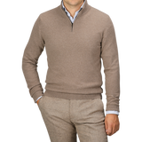 A person wearing a Daniele Fiesoli Light Brown Wool Cashmere Quarter Zip Sweater over a light blue shirt and beige pants, with their left hand in their pocket. Their face is not visible.