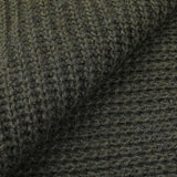 Close-up view of the Military Green Cable Knit Cashmere Scarf by Daniele Fiesoli, showcasing its ribbed texture in a rich green hue reminiscent of military attire.