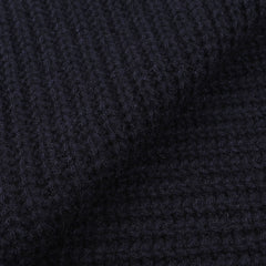 Close-up image of dark navy blue, cable knit fabric from an upcycled Daniele Fiesoli Navy Blue Cable Knit Cashmere Scarf.