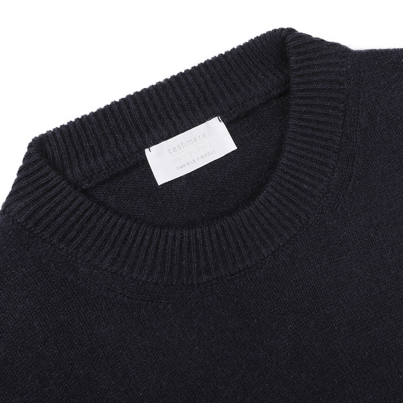 Close-up of the Daniele Fiesoli Navy Blue Cashmere Crewneck Sweater, featuring a white label at the neck and highlighting exquisite knitwear craftsmanship.