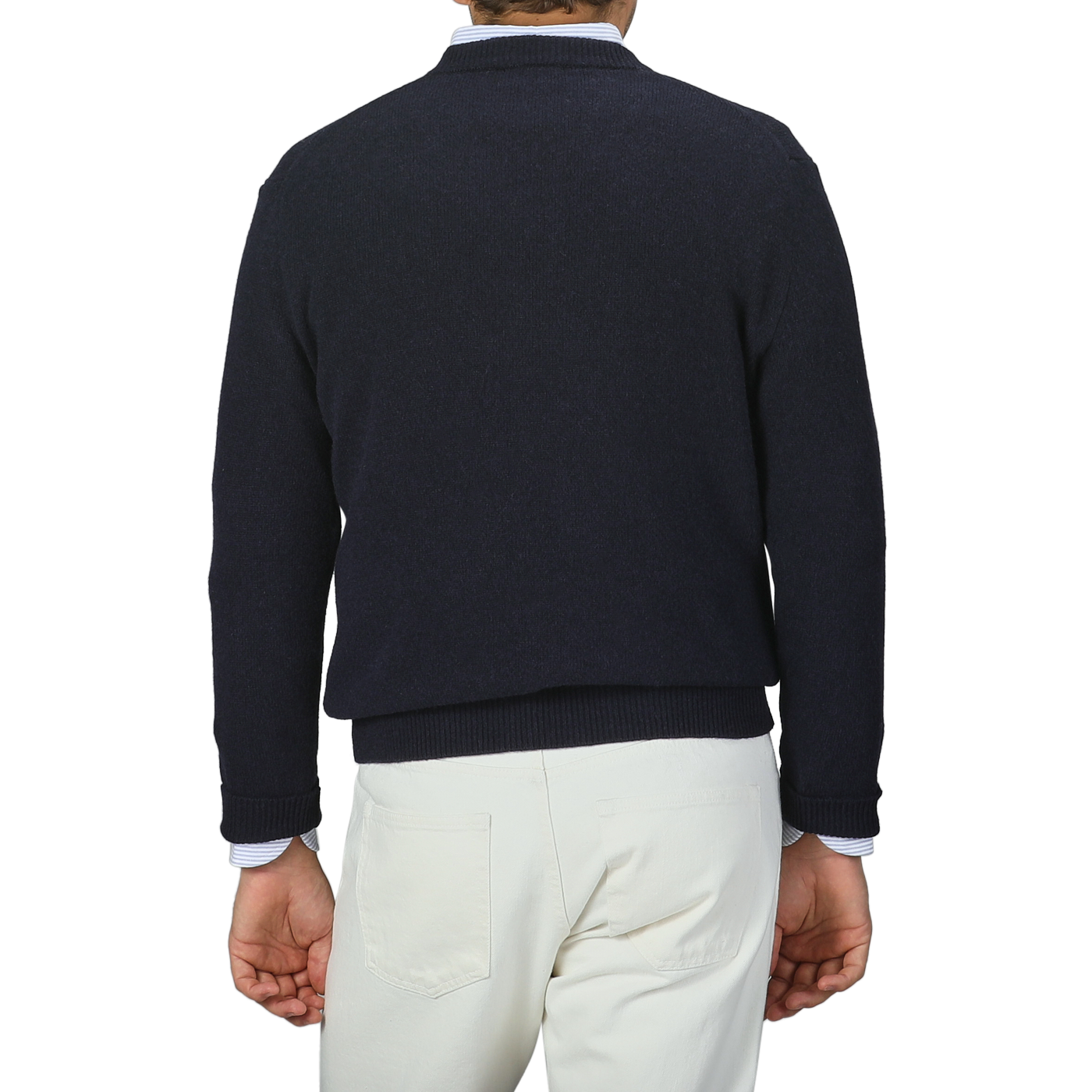 A person is seen from behind against a gray background, wearing a Daniele Fiesoli Navy Blue Cashmere V-Neck Sweater made in Italy paired with white pants.