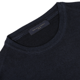 Close-up image of the Navy Blue Melange Merino Wool Crewneck, crafted by knitwear specialists from luxurious merino wool, featuring a label with "DANIELE FIESOLI" sewn on the inside neckline.