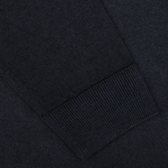 Close-up of a dark fabric sleeve with a ribbed cuff. The texture of the Navy Blue Melange Merino Wool Crewneck by Daniele Fiesoli and the stitching details are clearly visible—expertly crafted by knitwear specialists for a regular fit.