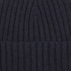 Close-up of a navy blue cashmere beanie with vertical ribbed texture by Daniele Fiesoli.