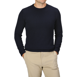 A person wearing a Daniele Fiesoli Navy Blue Wool Cashmere Crewneck and beige pants with their hands in their pockets. The person's face is not visible.