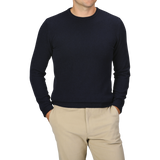 A person wearing a Daniele Fiesoli Navy Blue Wool Cashmere Crewneck and beige pants with their hands in their pockets. The person's face is not visible.