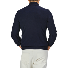 A person is seen from the back wearing a Daniele Fiesoli Navy Blue Wool Cashmere Quarter Zip Sweater and light-colored pants.