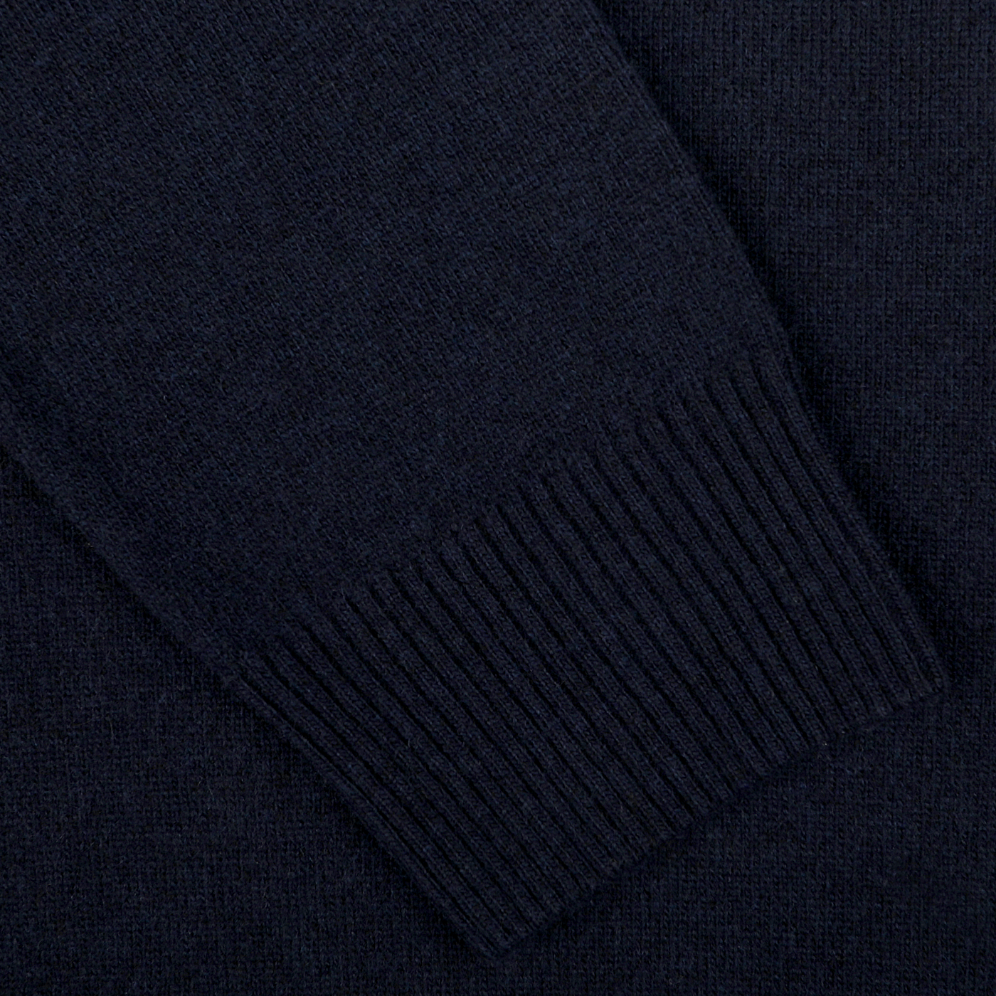 Close-up view of the ribbed cuff detailing on the sleeve of a Navy Blue Wool Cashmere Quarter Zip Sweater by Daniele Fiesoli.