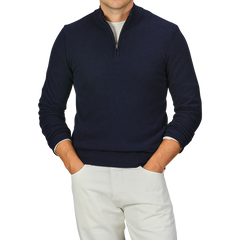 A person wearing a Navy Blue Wool Cashmere Quarter Zip Sweater by Daniele Fiesoli, paired with light-colored pants, stands with hands in pockets. The person's head is not visible in the image.