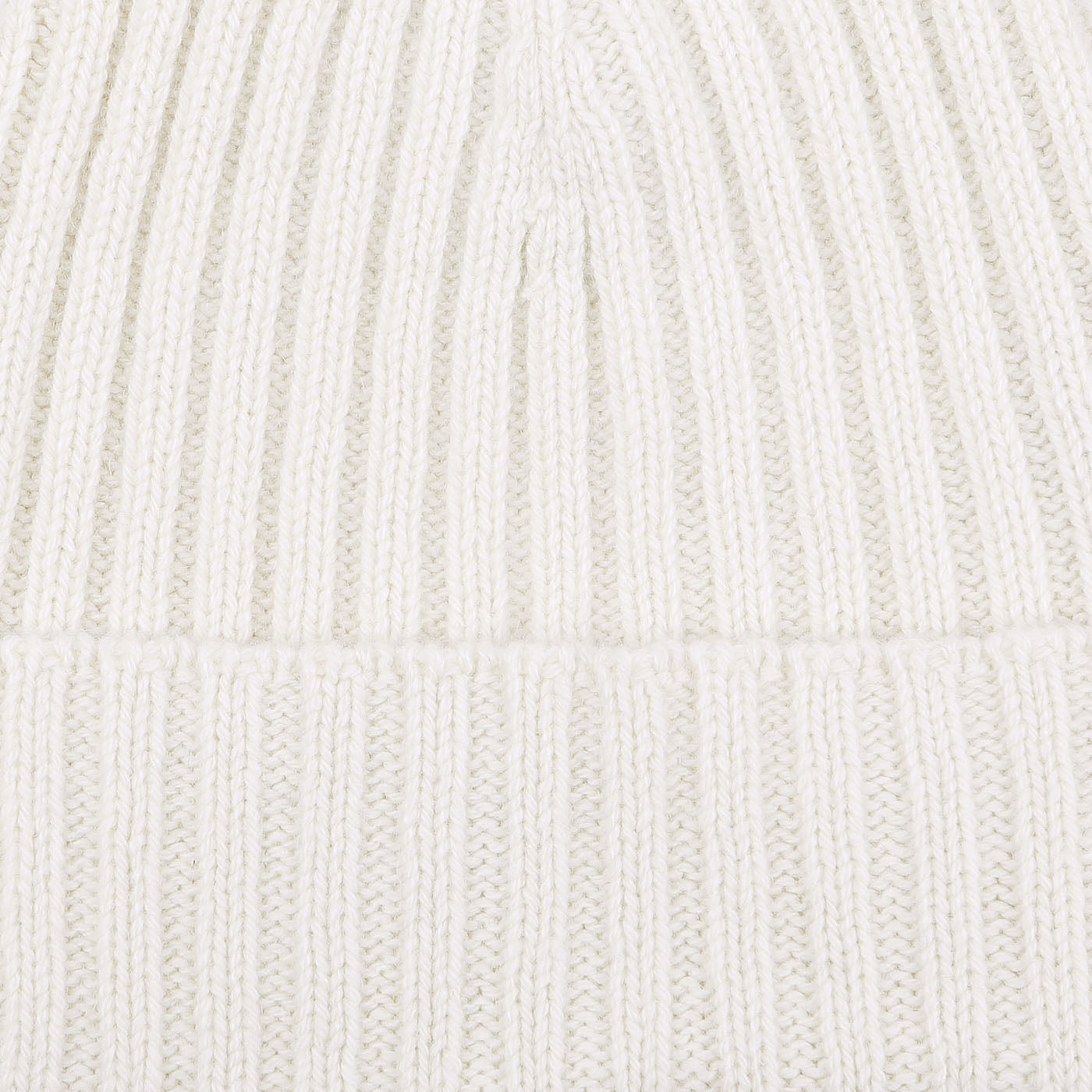 Close-up of the Nuvola Ecru Ribbed Cashmere Beanie by Daniele Fiesoli, showcasing its white, ribbed knit fabric with vertical lines and a folded section near the bottom, reminiscent of Italian knitwear.