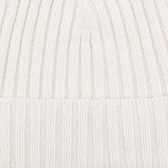 Close-up of the Nuvola Ecru Ribbed Cashmere Beanie by Daniele Fiesoli, showcasing its white, ribbed knit fabric with vertical lines and a folded section near the bottom, reminiscent of Italian knitwear.