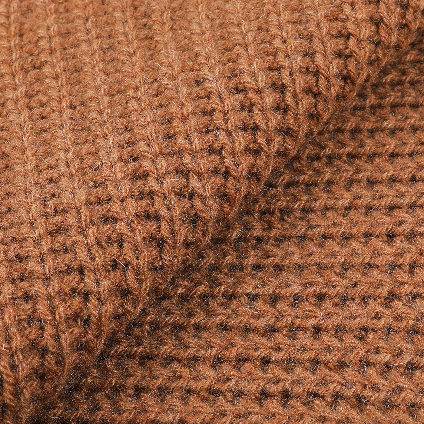 Close-up of a Daniele Fiesoli Rhum Brown Cable Knit Cashmere Scarf, showcasing its ribbed and checkered pattern that emphasizes the fibrous and warm appearance.