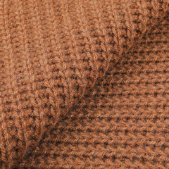 Close-up of a Daniele Fiesoli Rhum Brown Cable Knit Cashmere Scarf, showcasing its ribbed and checkered pattern that emphasizes the fibrous and warm appearance.