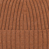 Close-up image of the Rhum Brown Ribbed Cashmere Beanie by Daniele Fiesoli, crafted by an Italian knitwear specialist in a rust orange hue, showcasing the detailed ribbed texture.