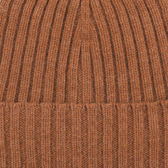 Close-up image of the Rhum Brown Ribbed Cashmere Beanie by Daniele Fiesoli, crafted by an Italian knitwear specialist in a rust orange hue, showcasing the detailed ribbed texture.