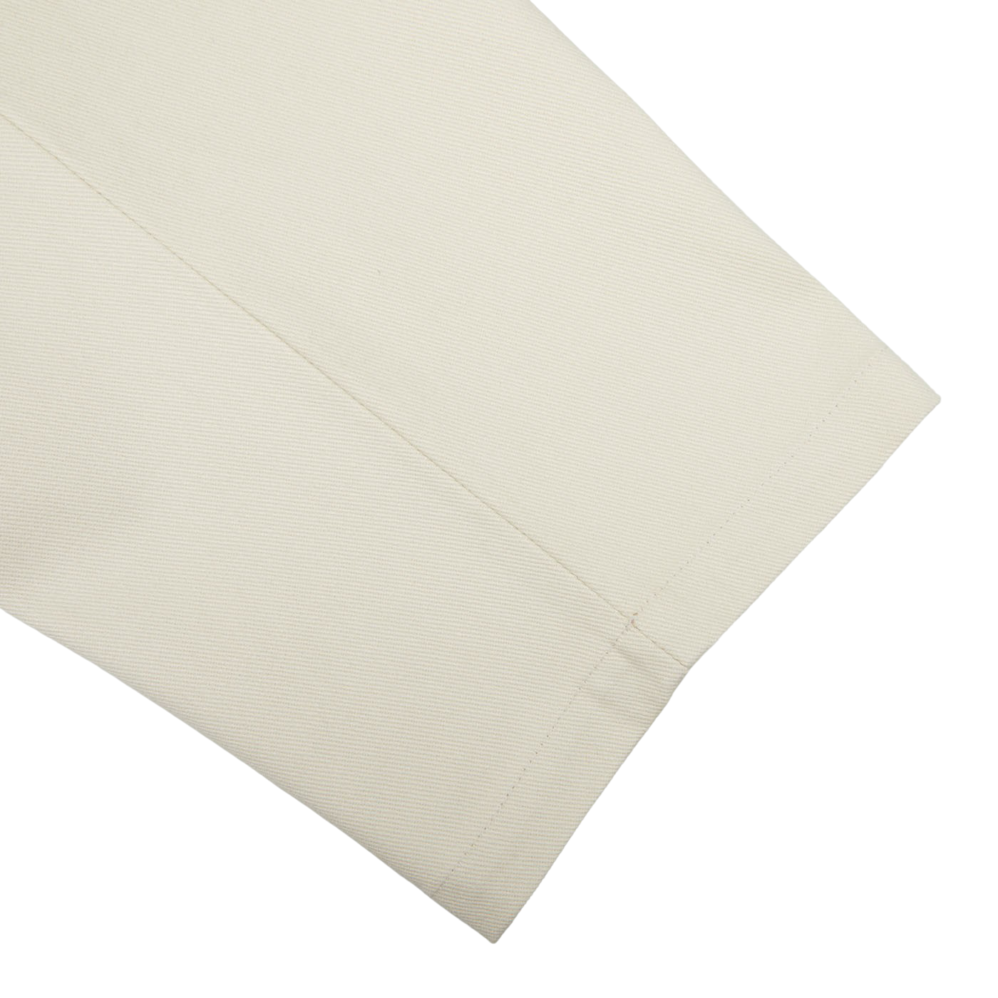 Close-up of De Bonne Facture undyed heavy cotton drill balloon trousers with visible stitching on a plain background.