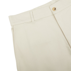 Close-up of a beige De Bonne Facture Undyed Heavy Cotton Drill Balloon Trousers waistband with a button closure.