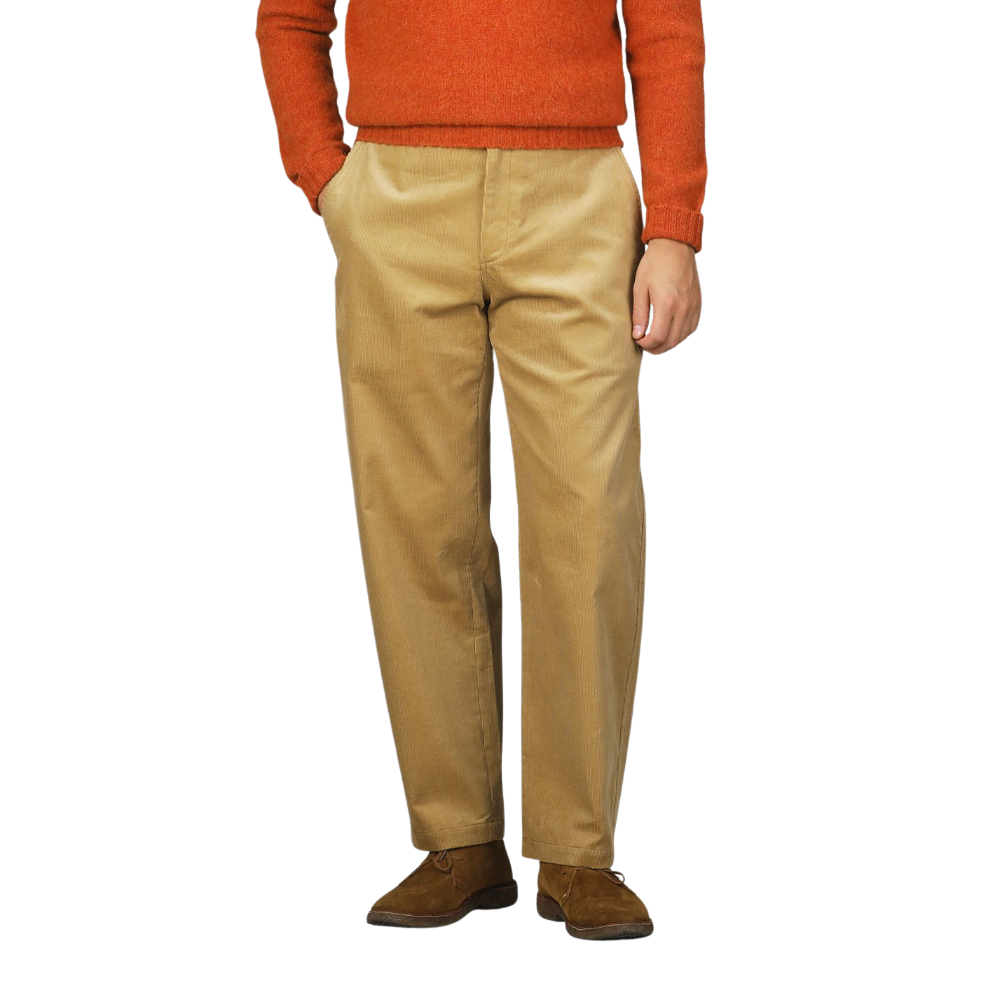 Person wearing a gold mustard cotton corduroy balloon trousers by De Bonne Facture with hands in pockets, standing against a plain background.