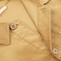 Close-up of gold mustard cotton corduroy fabric with visible buttons and stitching on the classic Gold Mustard Cotton Corduroy Work Jacket, crafted by De Bonne Facture.