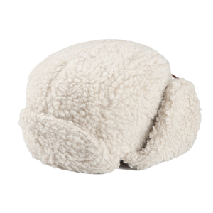 The Natural Wool Fleece Chapka Hat by De Bonne Facture is an elegant white sherpa fleece hat with earflaps, crafted from natural wool fleece and featuring a stylish calf leather string fastening. It is beautifully showcased against a plain background.