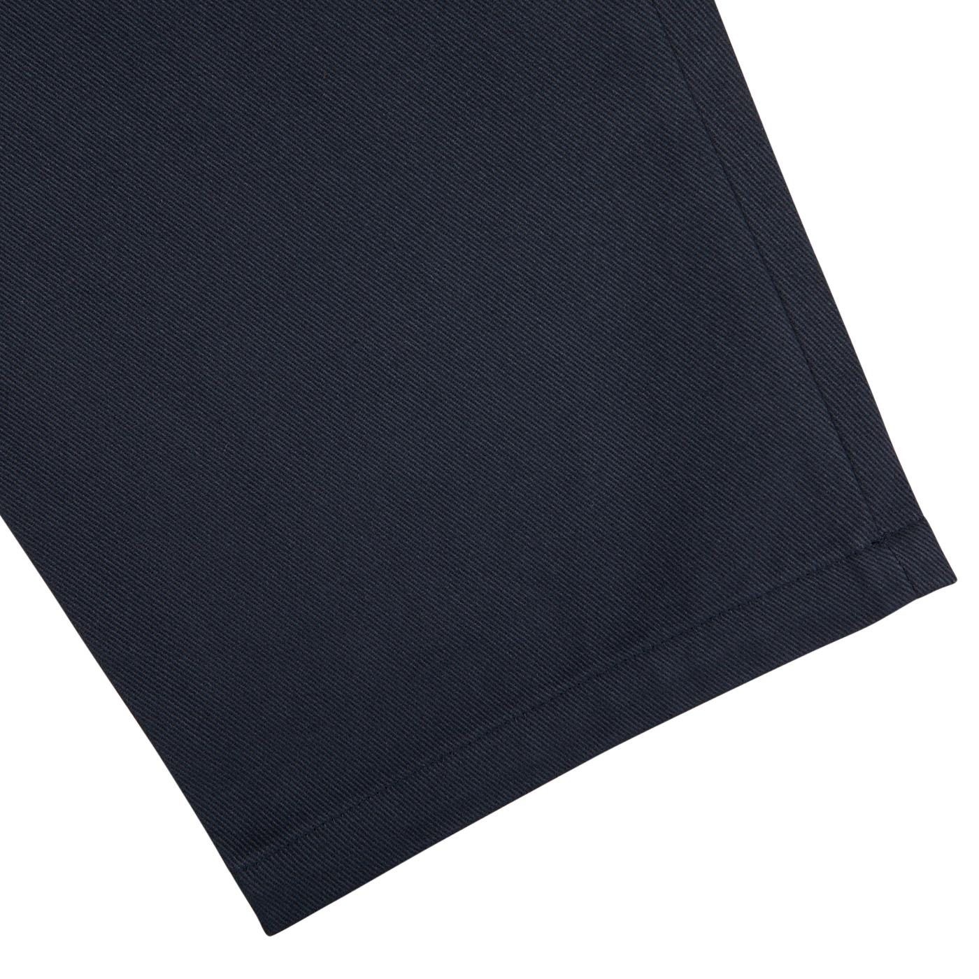 Close-up of De Bonne Facture Navy Blue Heavy Cotton Drill Balloon Trousers fabric texture with visible weave patterns on a light background.