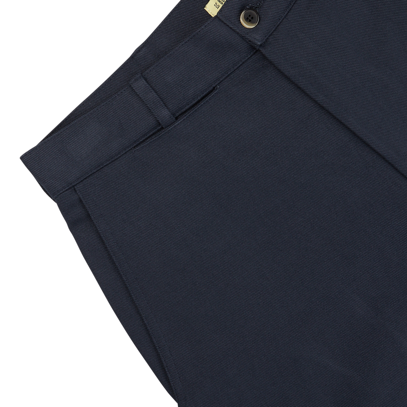 Close-up of De Bonne Facture navy blue heavy cotton drill balloon trousers, showing detailed texture and a button closure in heavy cotton drill fabric.
