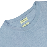 Close-up of a Smoke Blue Linen Jersey Oversized T-shirt neckline featuring a label with the brand name "De Bonne Facture" and additional text.