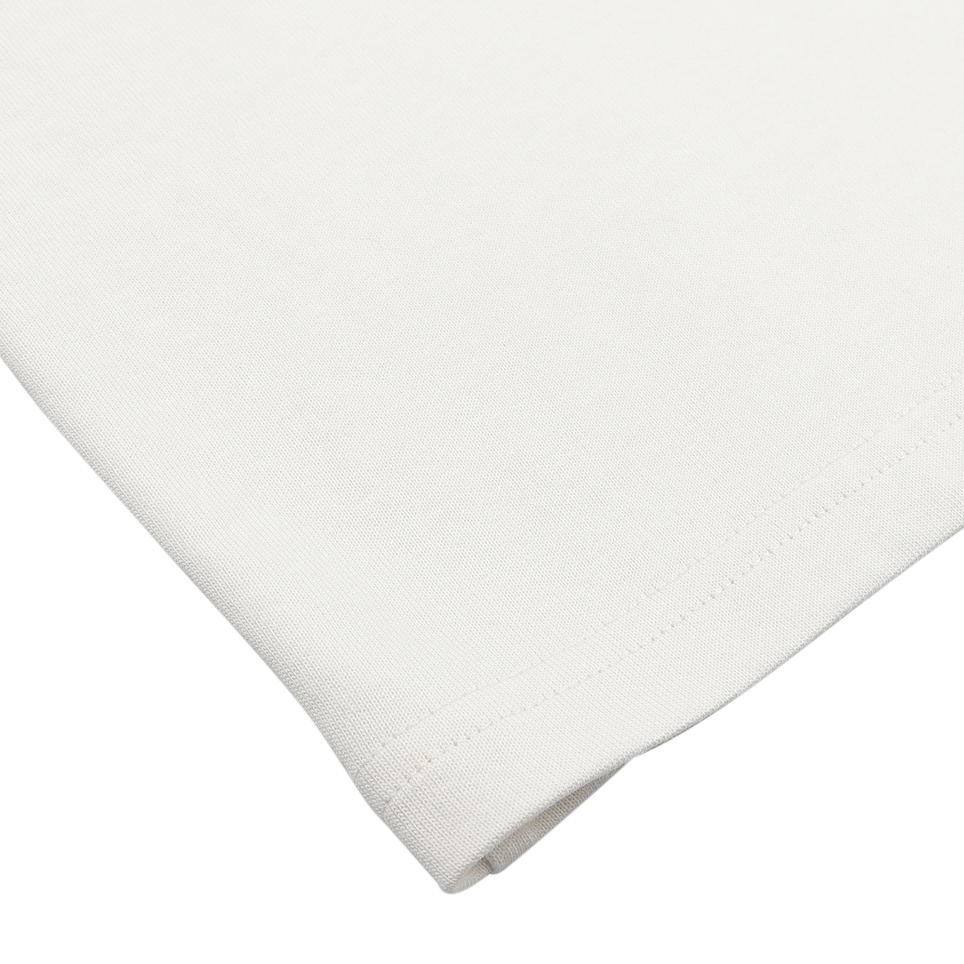 Close-up of a plain white fabric with visible stitching along the edge, reminiscent of De Bonne Facture's Undyed Printed Cotton Jersey T-Shirt.