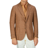 A man showcasing his excellent tailoring skills in a De Petrillo Brown Checked Wool Silk Linen Posillipo Blazer, a mustard shirt, and white trousers.