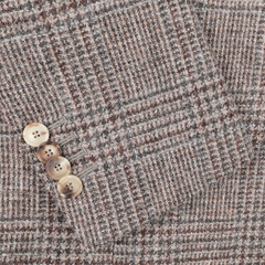 Close-up of the De Petrillo Brown Checked Wool Tweed Posillipo Blazer fabric, showcasing a brown and gray checkered pattern with four light brown buttons on the cuff.