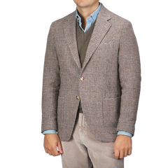 A man is sporting the Brown Checked Wool Tweed Posillipo Blazer by De Petrillo over a brown sweater and a blue button-up shirt, paired with light-colored corduroy pants.