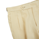 A pair of Caramel Beige Irish Linen Modello B trousers with buttons on the side from De Petrillo.