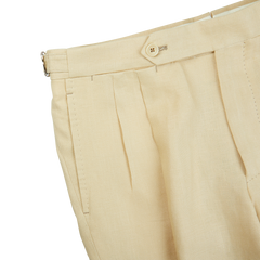 A pair of Caramel Beige Irish Linen Modello B trousers with buttons on the side from De Petrillo.