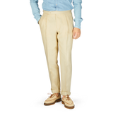 A man in a blue De Petrillo shirt and Caramel Beige Irish Linen Modello B trousers.
