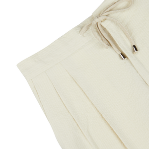 De Petrillo cream cotton seersucker drawstring trousers with pleat details.